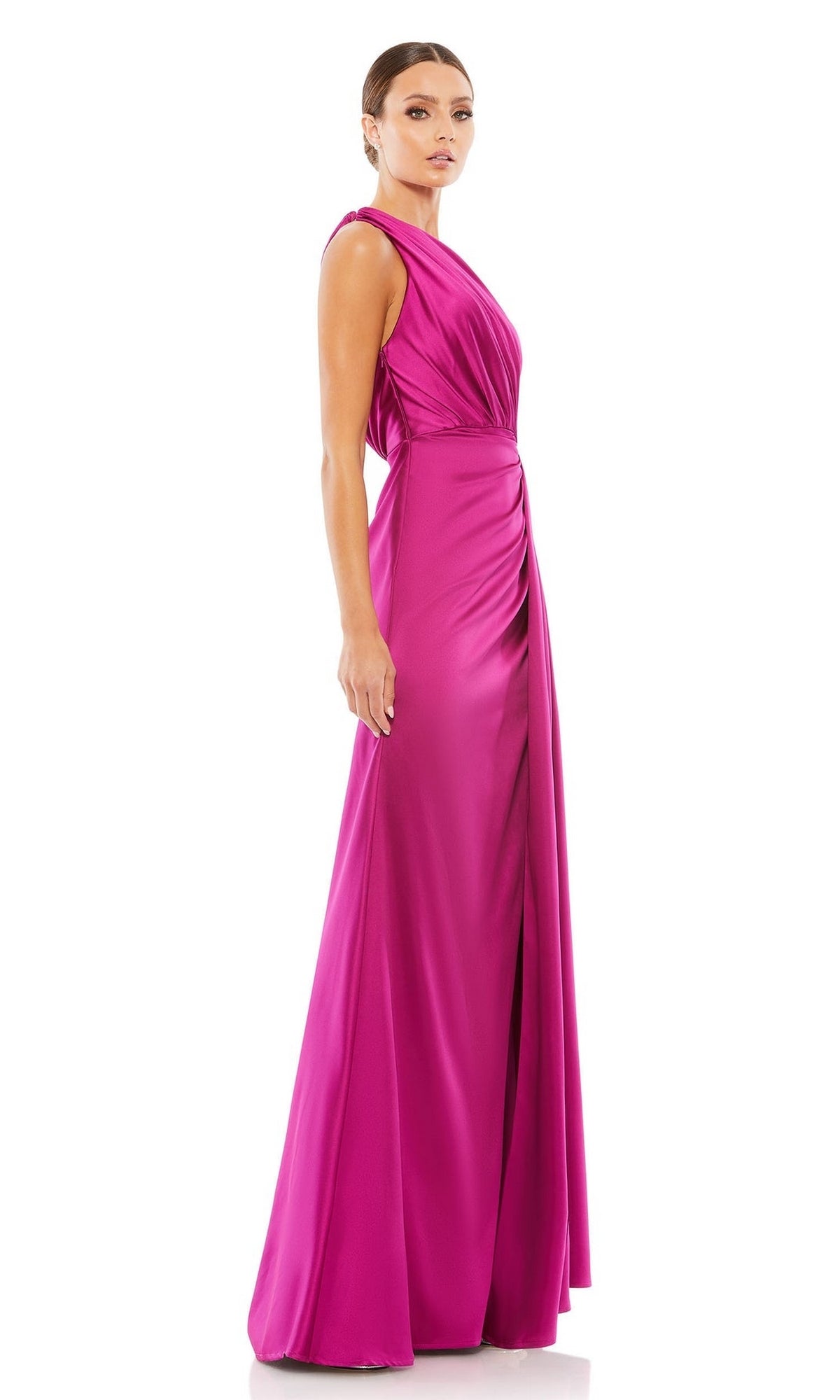 Woman in a Mac Duggal 26654 one-shoulder long formal dress—magenta, floor-length with a draped bodice and side slit—stands against a white background.